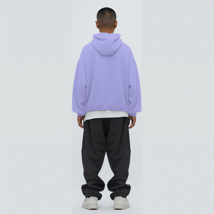 Person wearing a lavender hoodie and dark pants on a white background