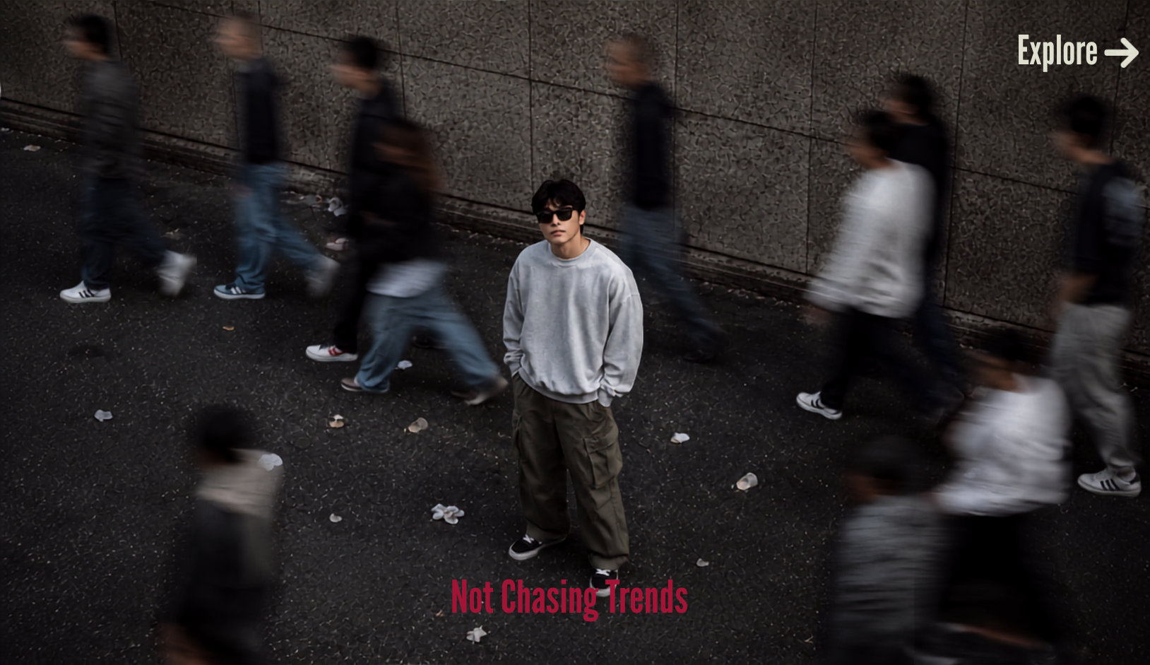 Man wearing an oversized grey sweatshirt and cargo pants in an urban street setting by Aethic Apparel, showcasing modern minimalist streetwear fashion
