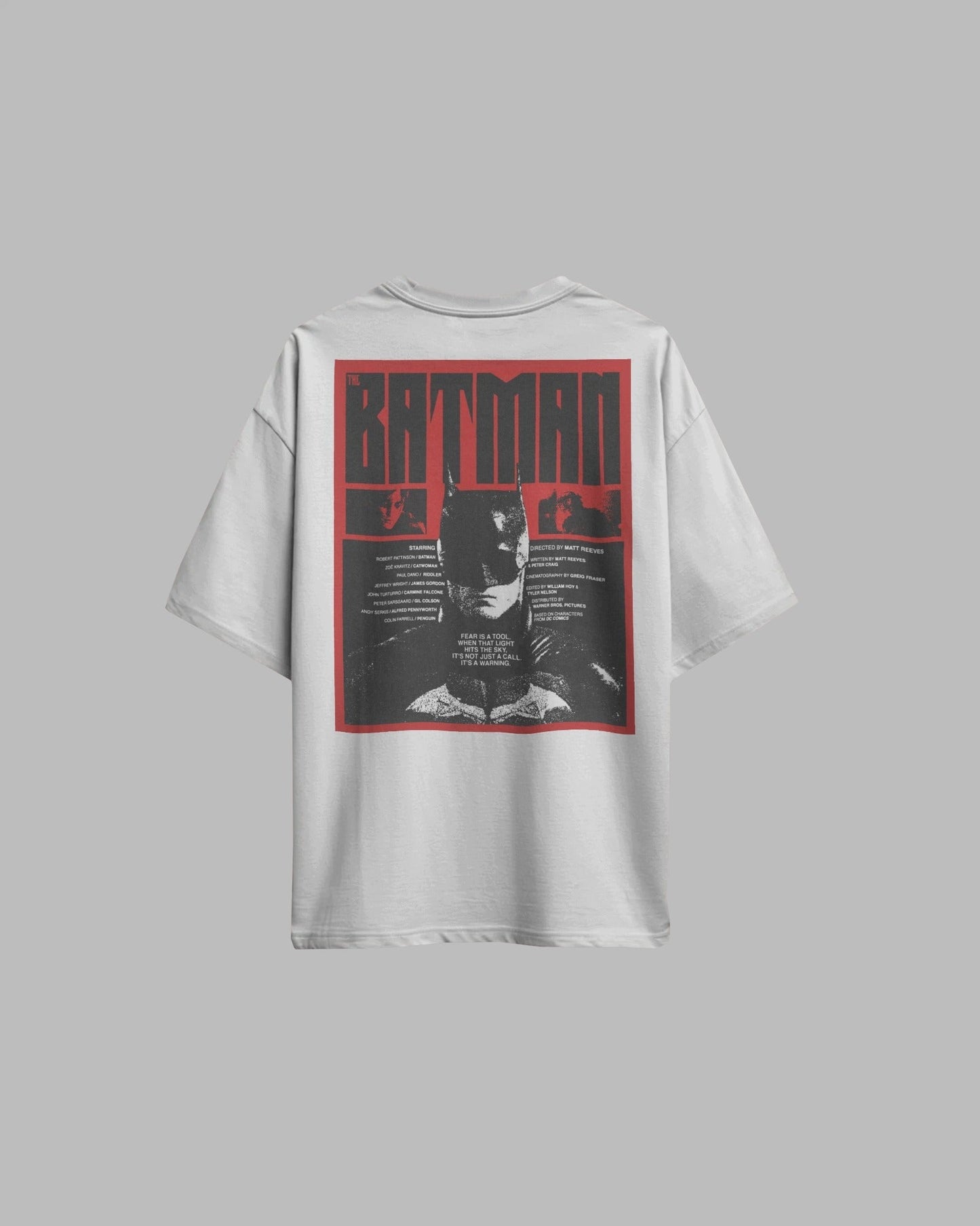 White t-shirt with Batman graphic on the back against a gray background