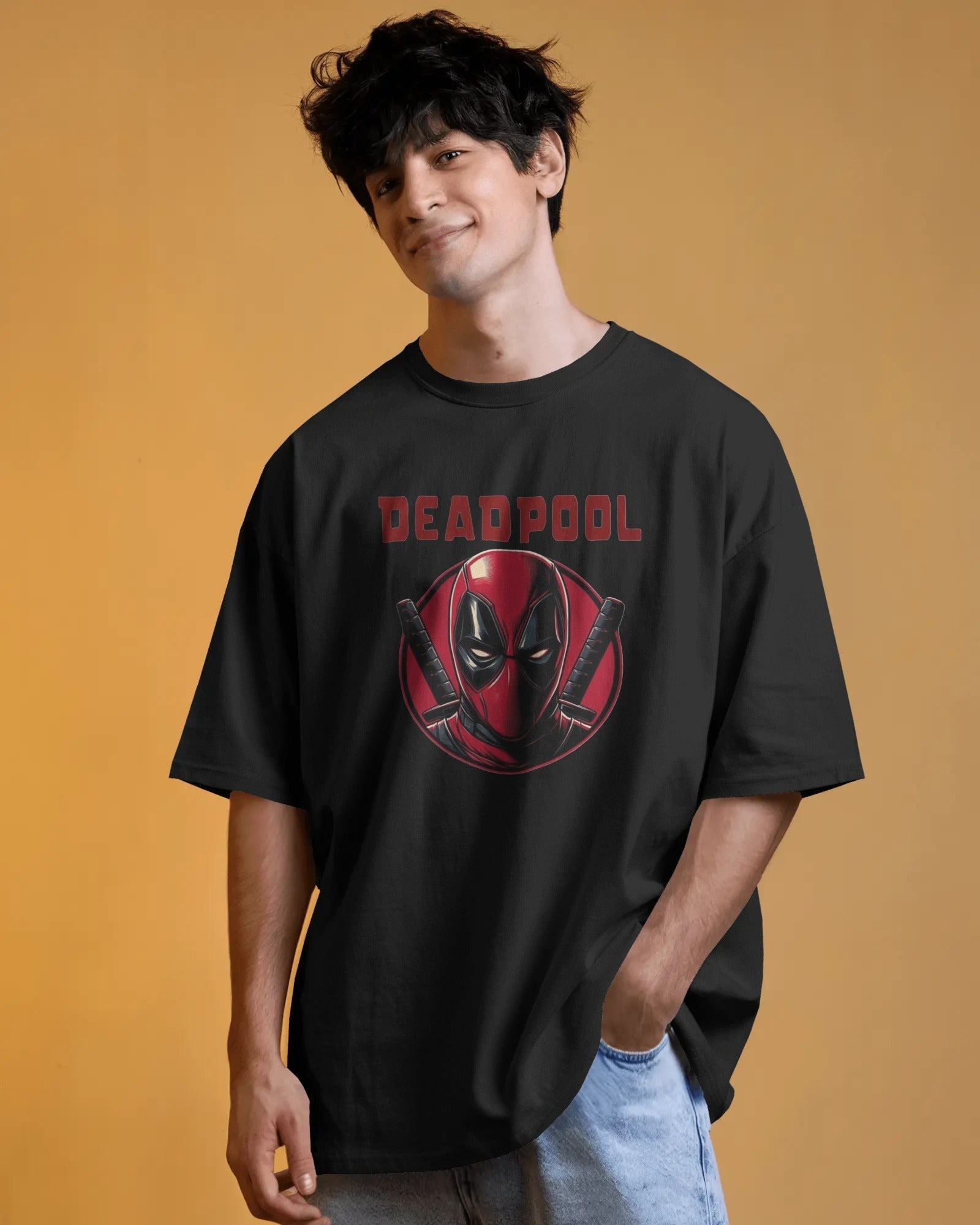 Person wearing a black 'Deadpool' t-shirt against an orange background