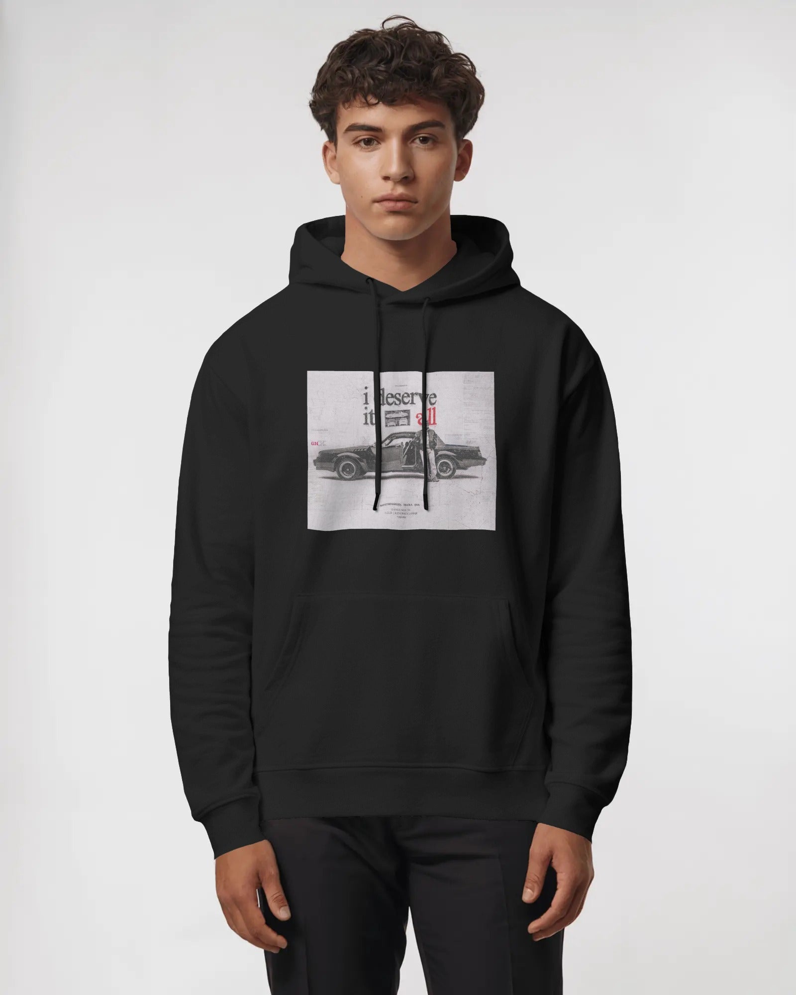 Person wearing a black hoodie with a graphic design on a white background