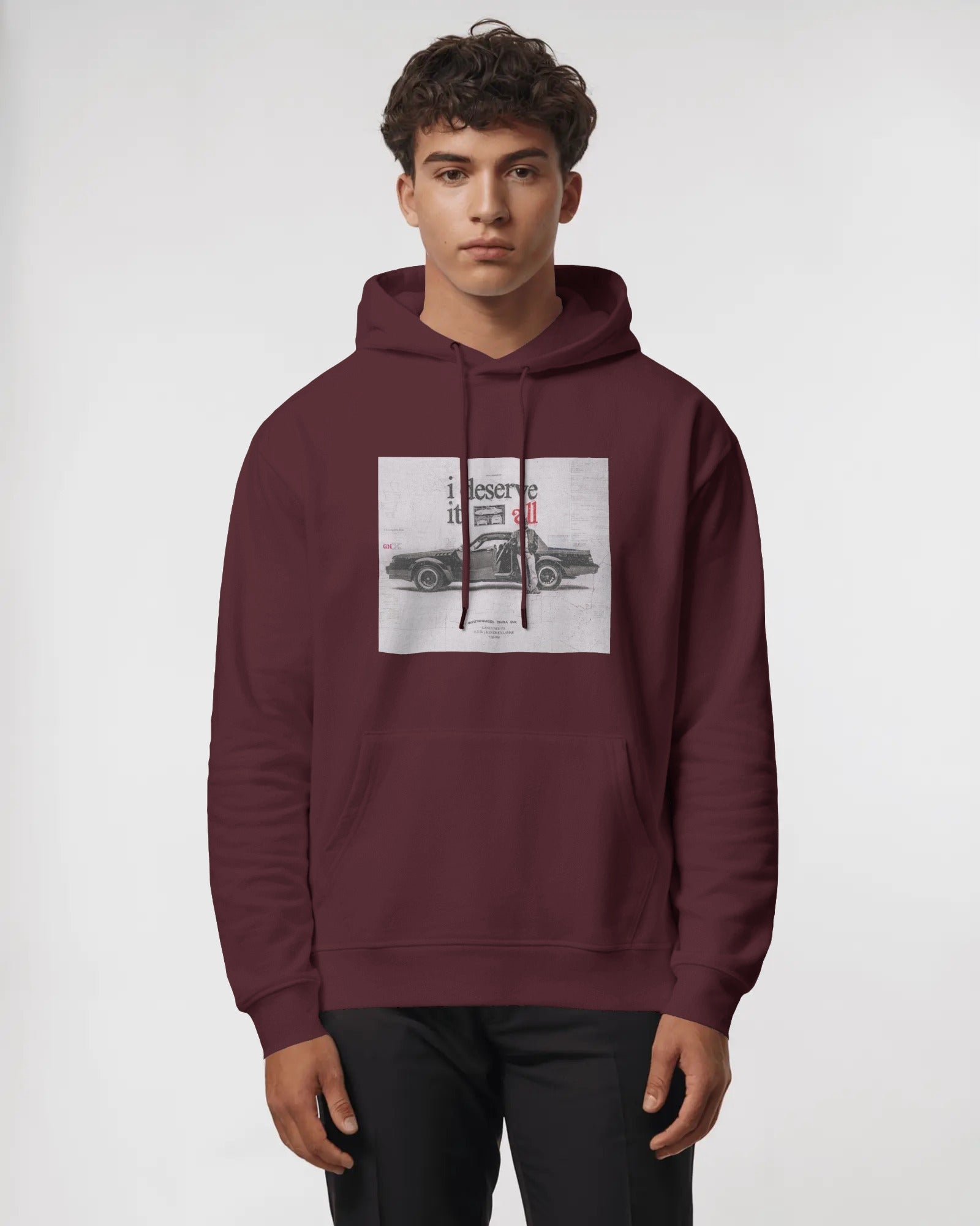 Person wearing a Color_maroon hoodie with a graphic design on a white background