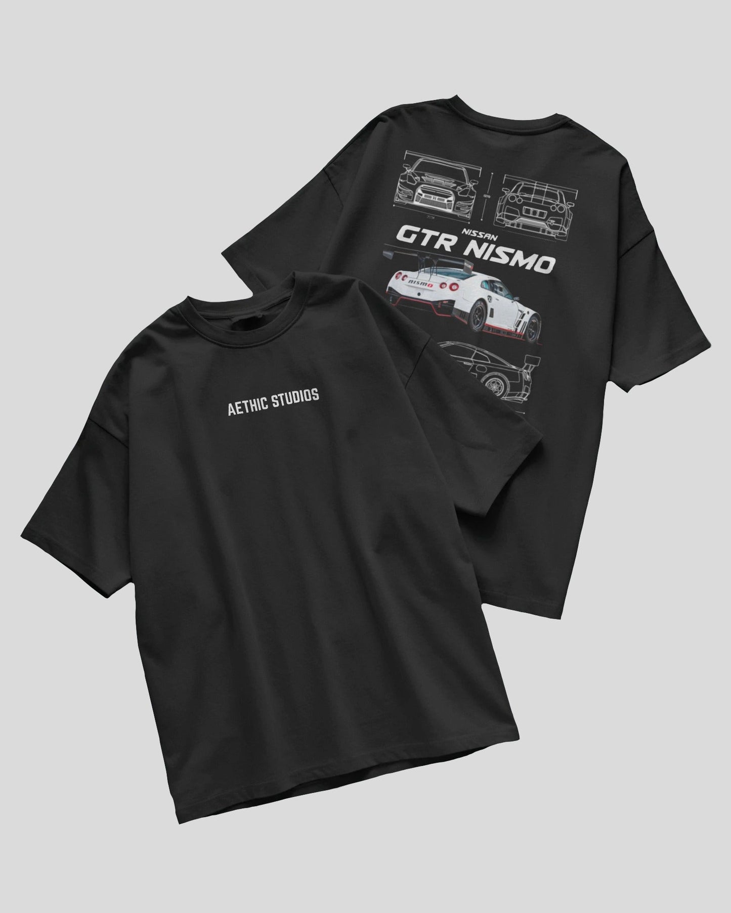 Two black t-shirts with car graphics and text on a gray background