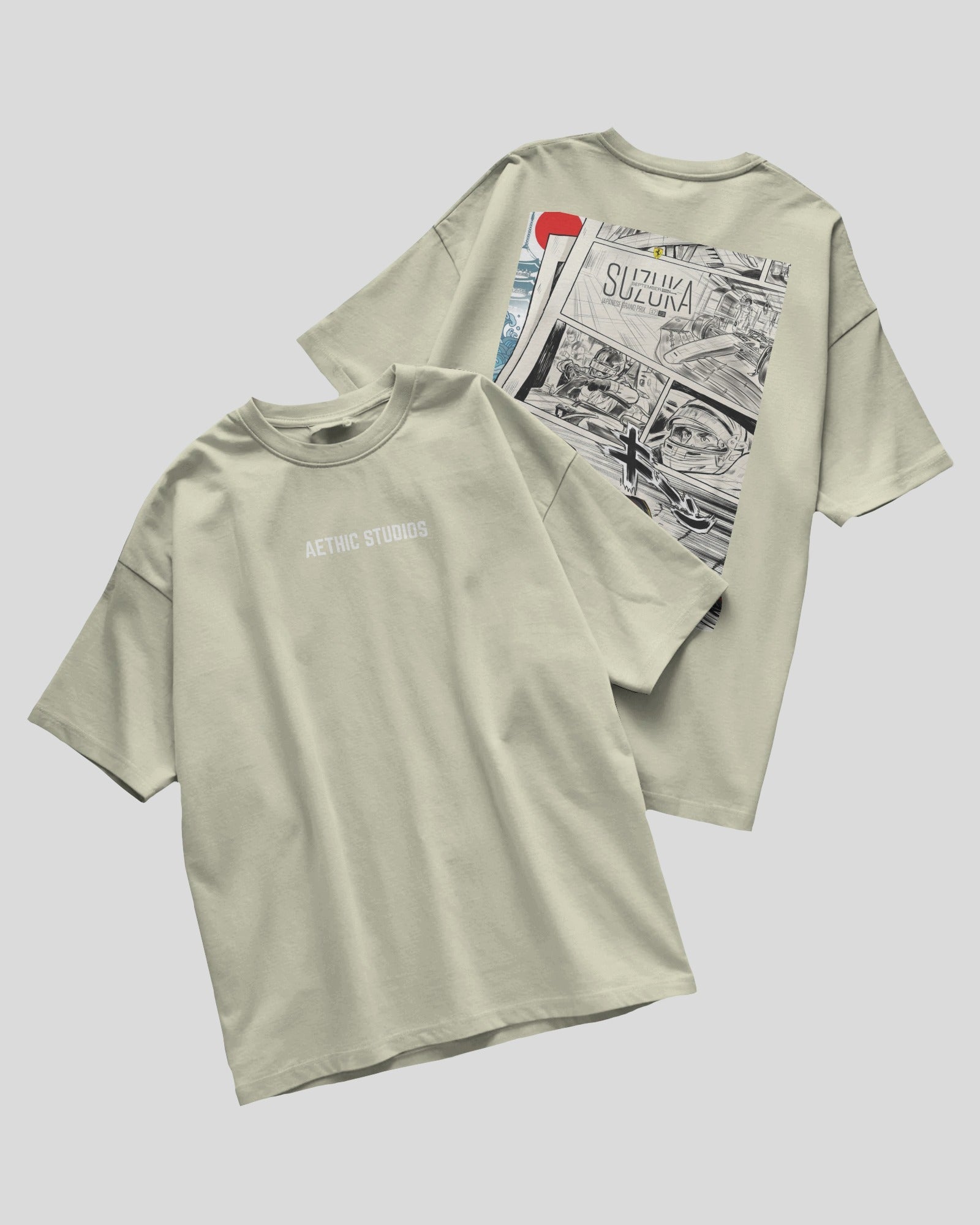 Two light green t-shirts with graphic designs on a gray background