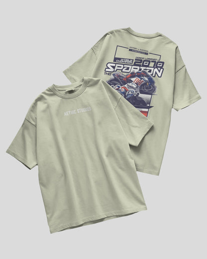 Light green t-shirt with graphic design on a gray background