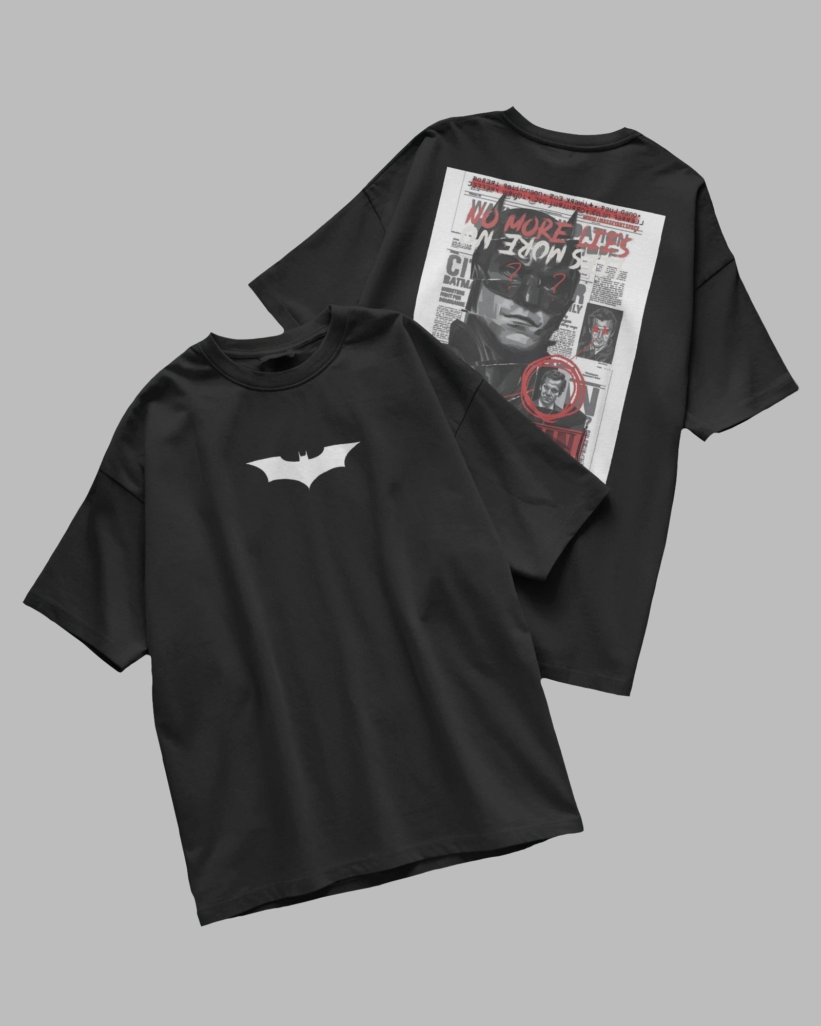 Two black t-shirts, one with a white bat logo and the other with a graphic design on the back, on a gray background.