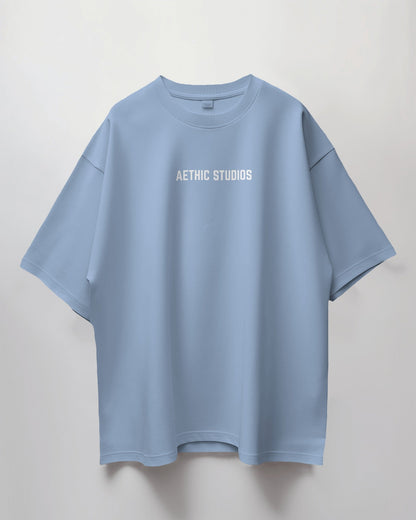 Light blue t-shirt with 'AETHIC STUDIOS' text on a light gray background