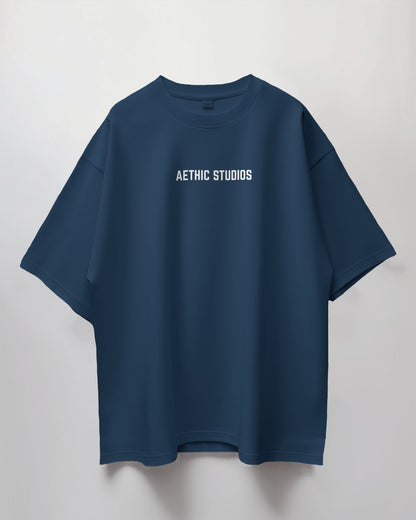 Blue t-shirt with 'Aethic Studios' text on a light gray background