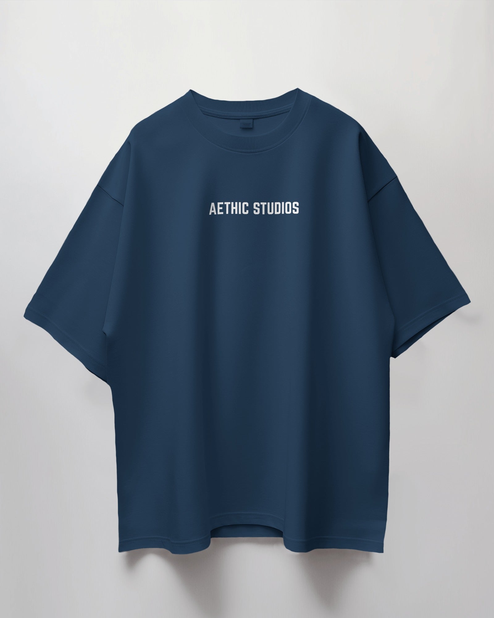 Blue t-shirt with 'Aethic Studios' text on a light gray background