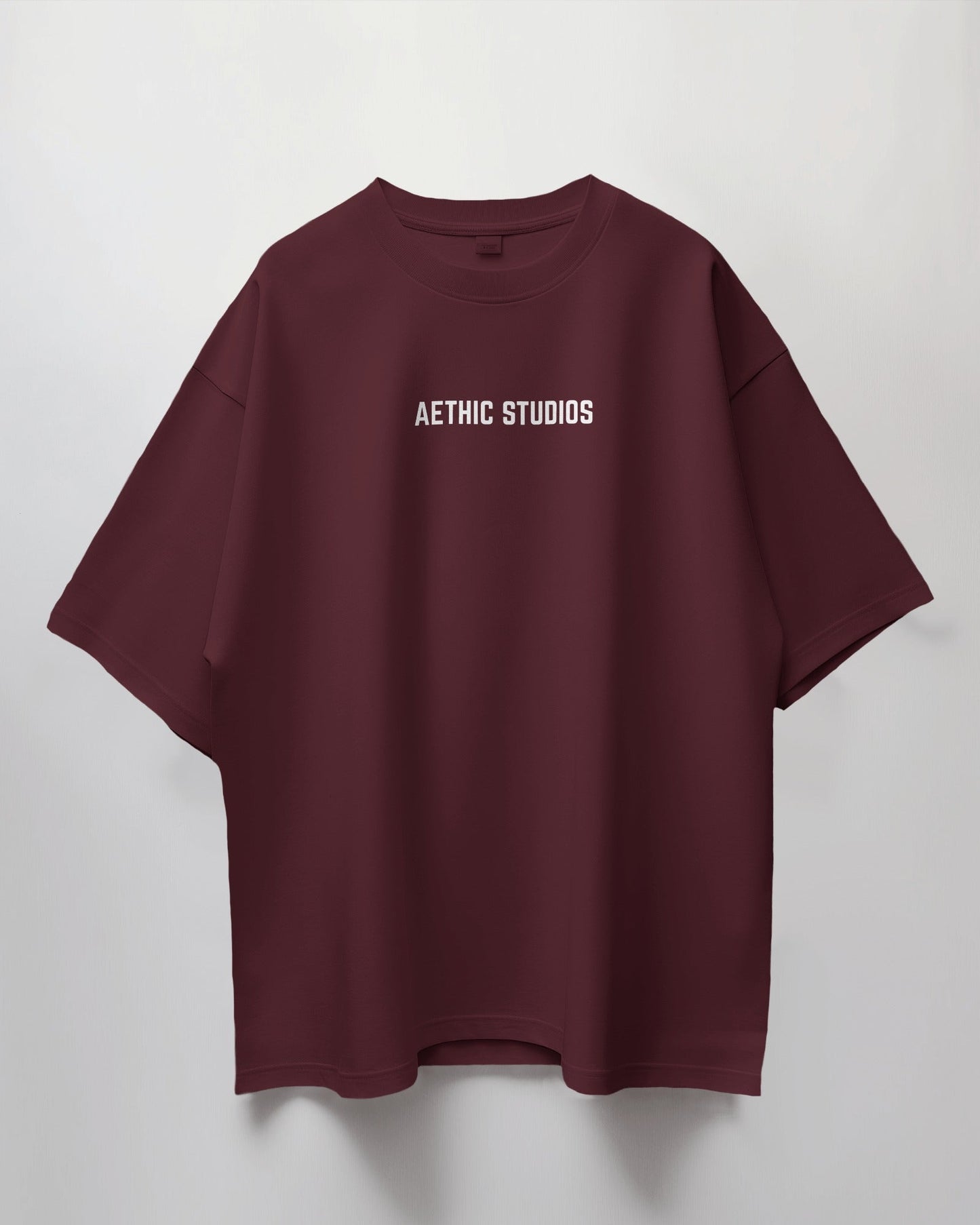 Maroon t-shirt with 'Aethic Studios' text on a light gray background