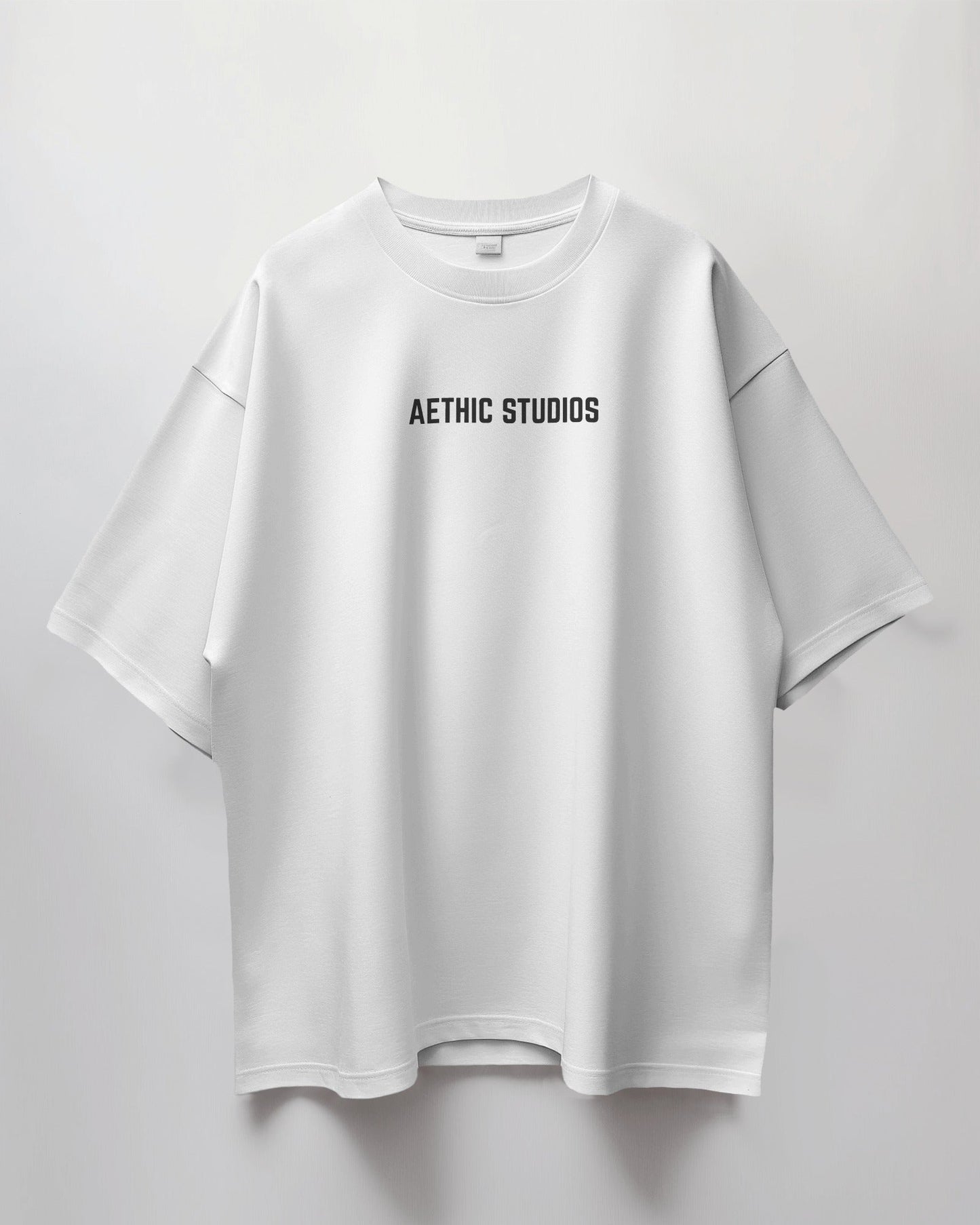White oversized t-shirt with Ready Set Go graphic design on the back and Aethic Studios text on the front