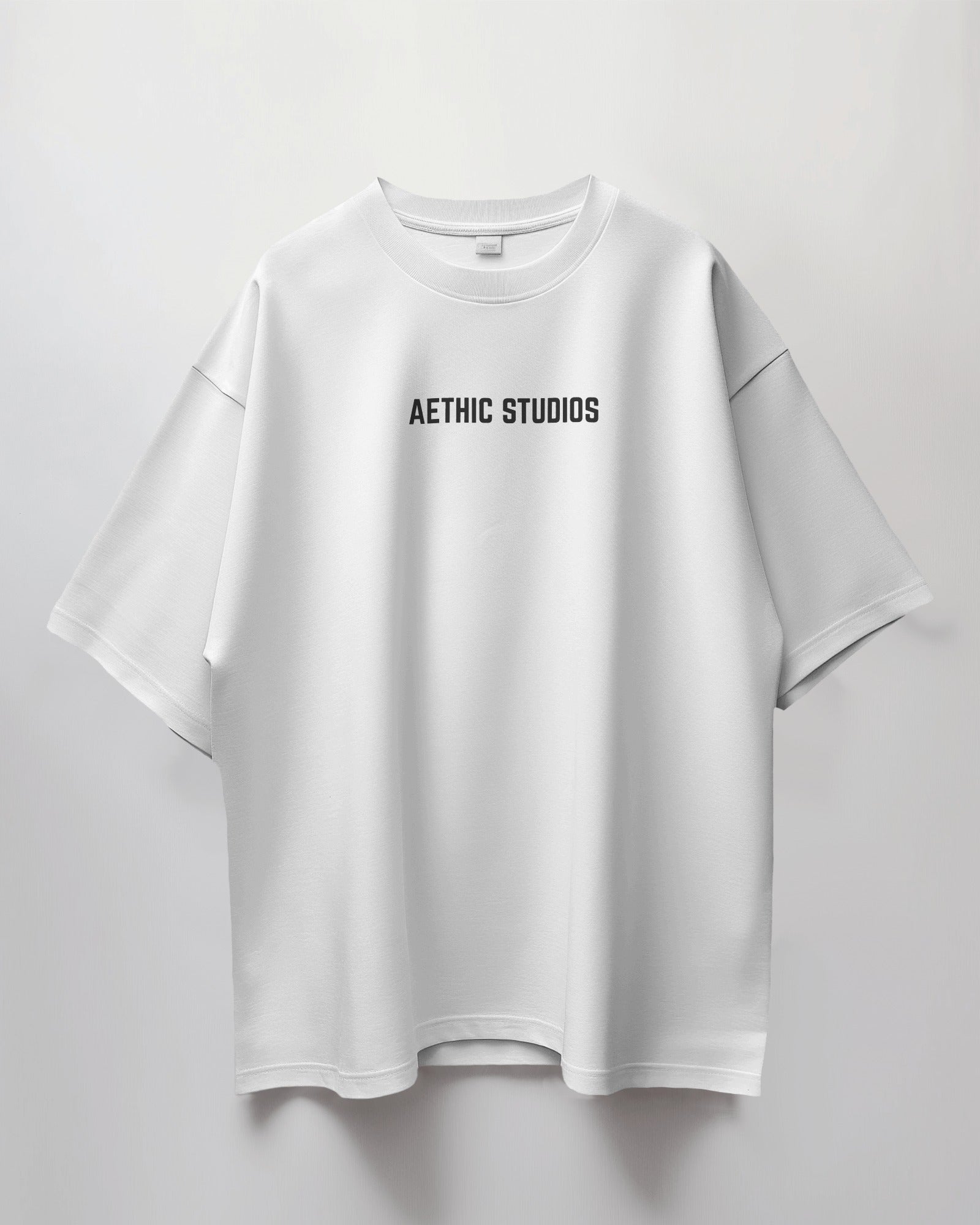 White t-shirt with 'Aethic Studios' text on a light gray background