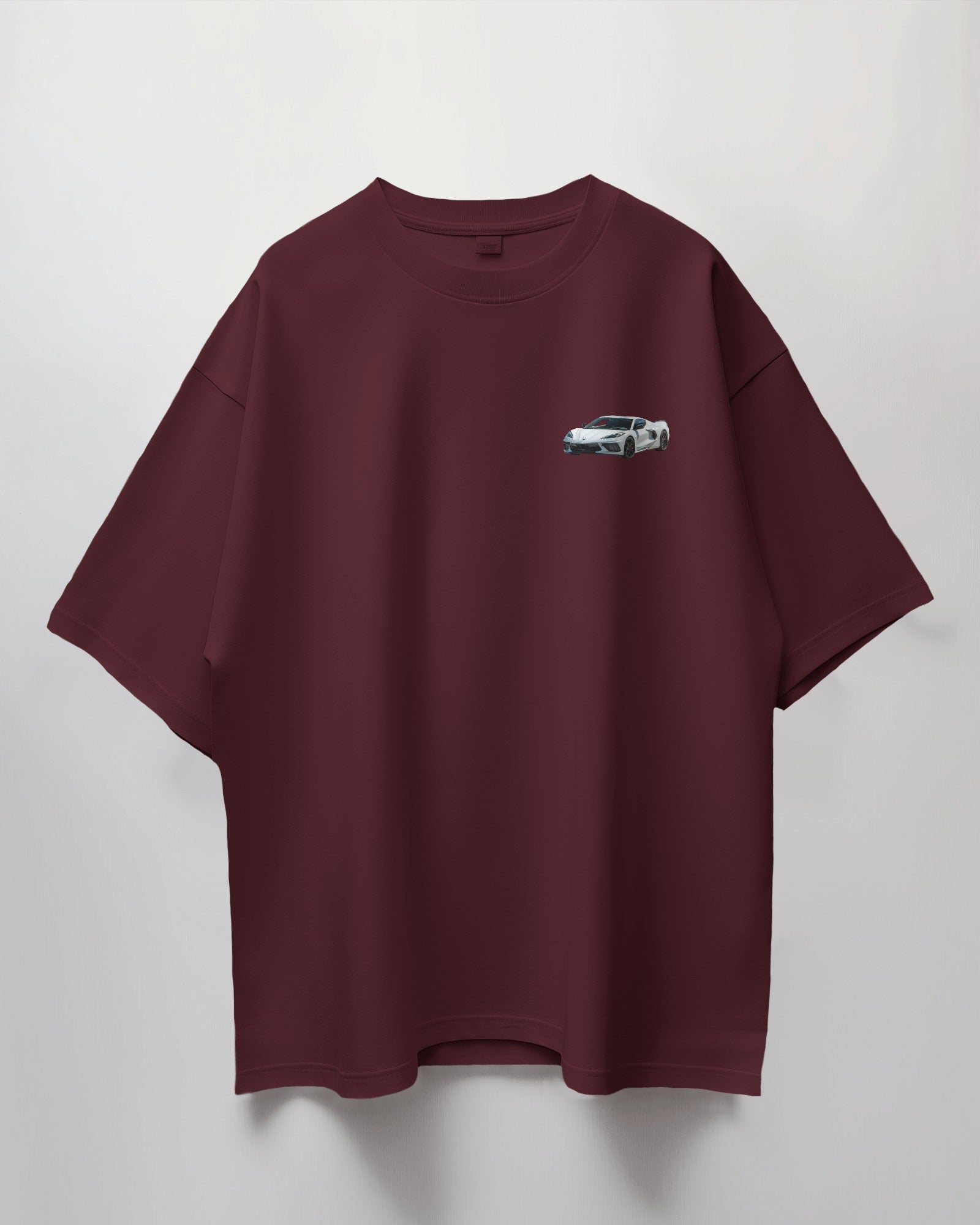 Colour_Maroon t-shirt with a small graphic on a light gray background