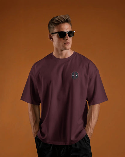 Man wearing a maroon t-shirt with a logo pf deadpool