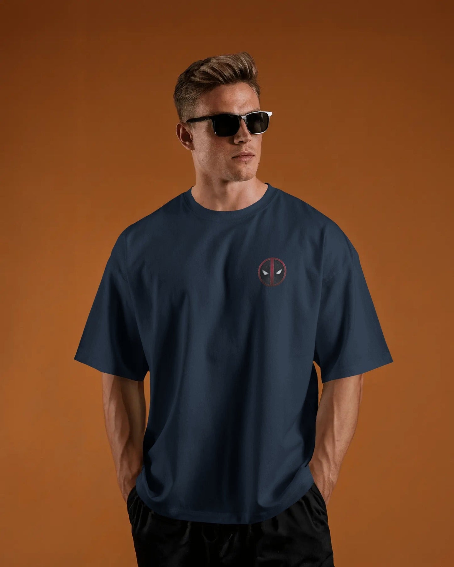 Man wearing a navy blue t-shirt with a logo of deadpool