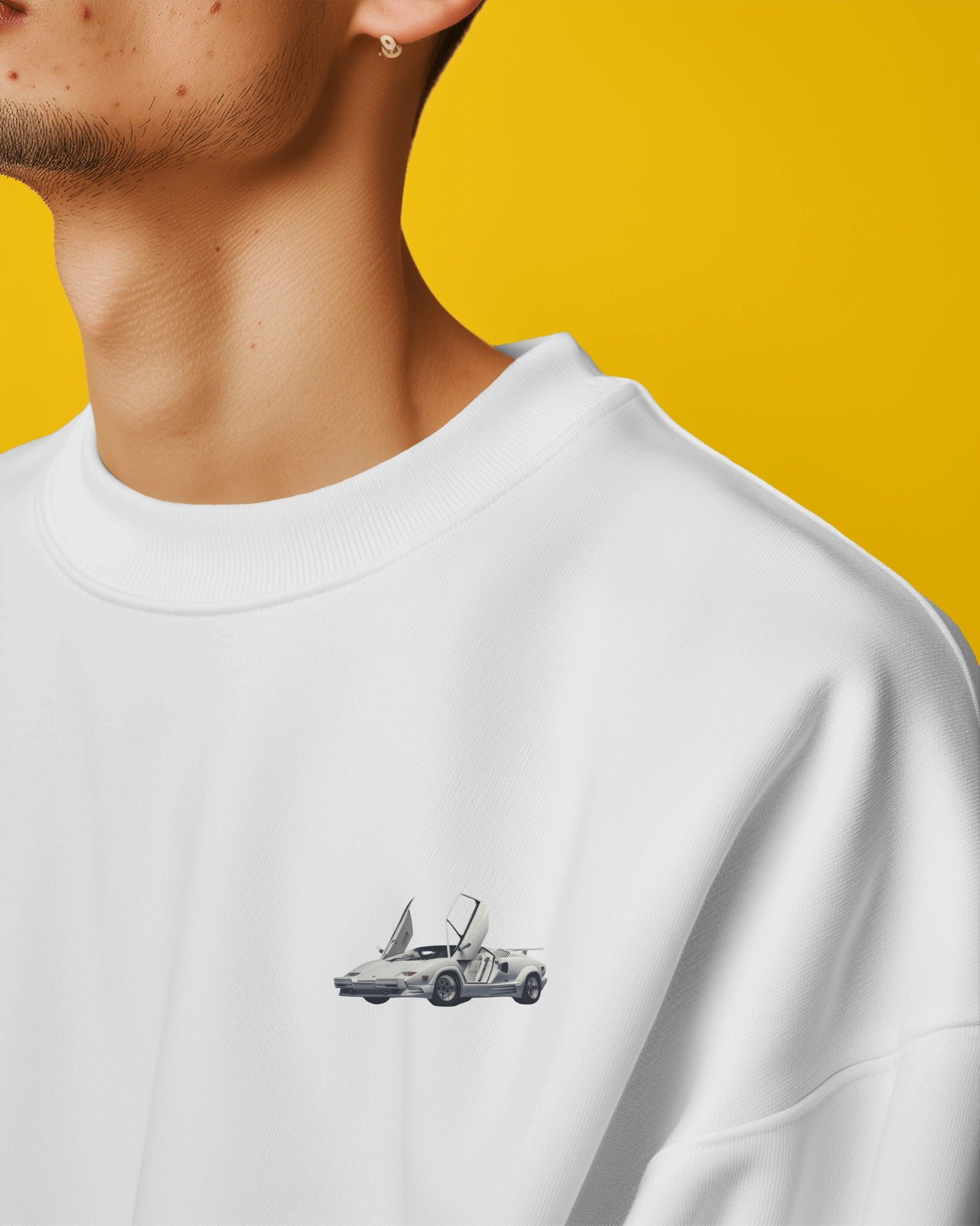 Close-up of white sweatshirt front with Lamborghini Countach mini car design