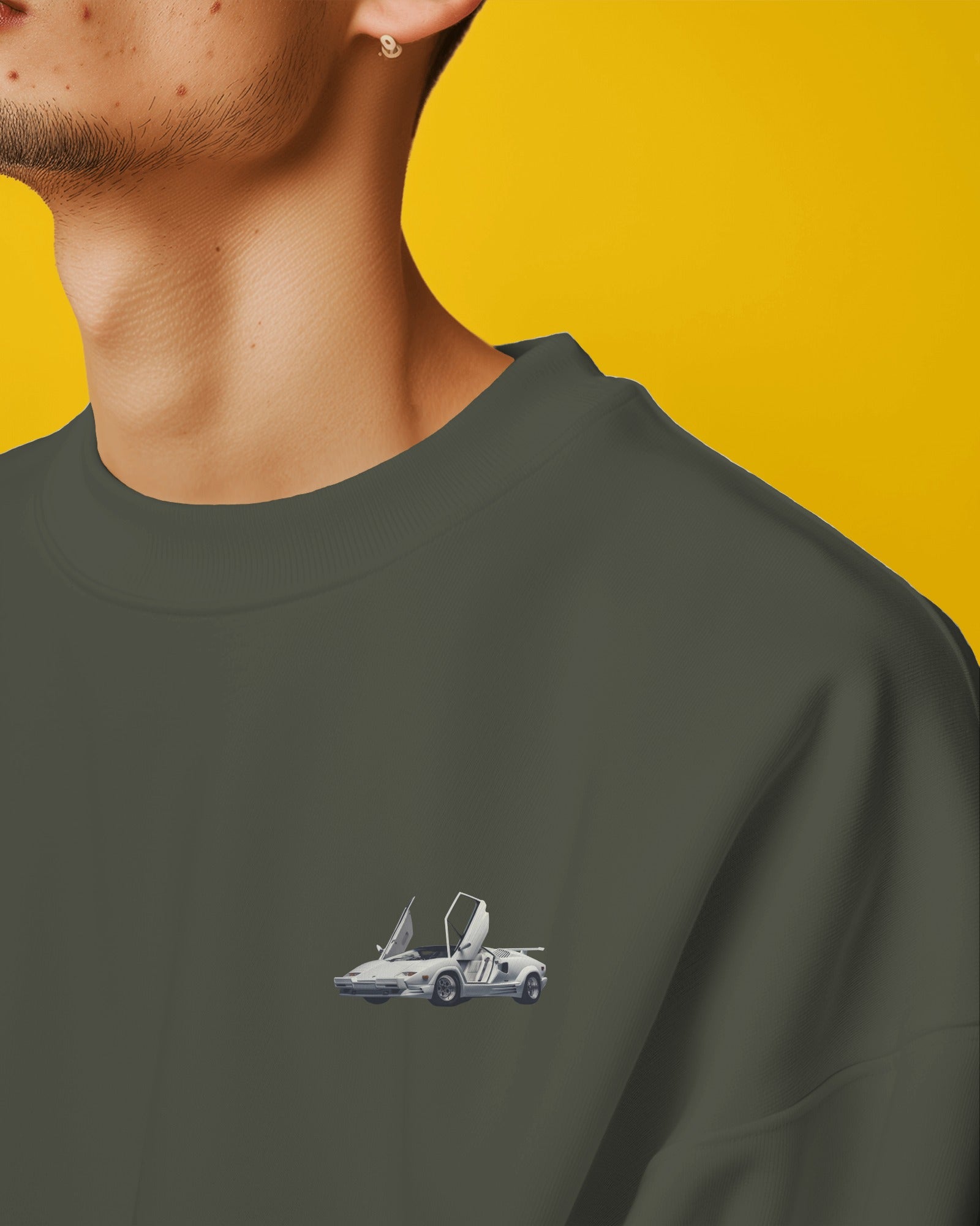 Close-up of green sweatshirt front with Lamborghini Countach mini car design