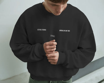 Person wearing a black sweatshirt with text against a light background