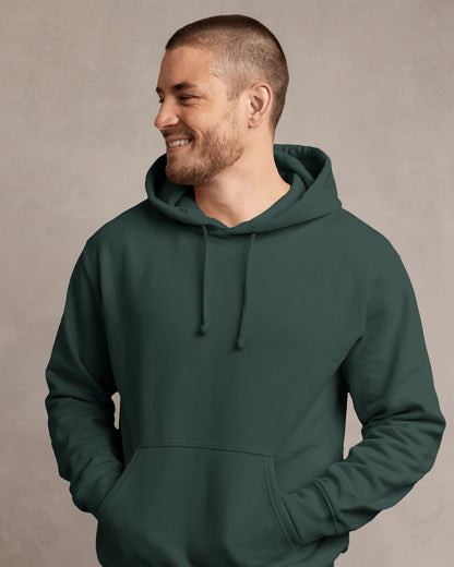 Man wearing a dark green hoodie against a neutral background
