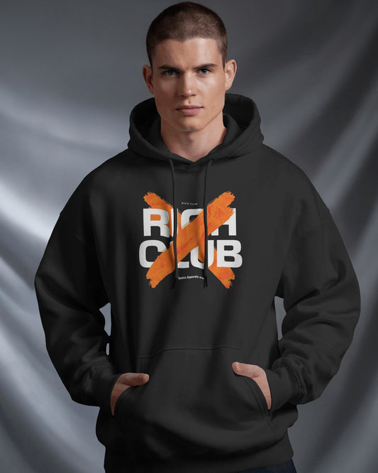 Man wearing a black hoodie with 'RICH CLUB' text and orange design on a gray background