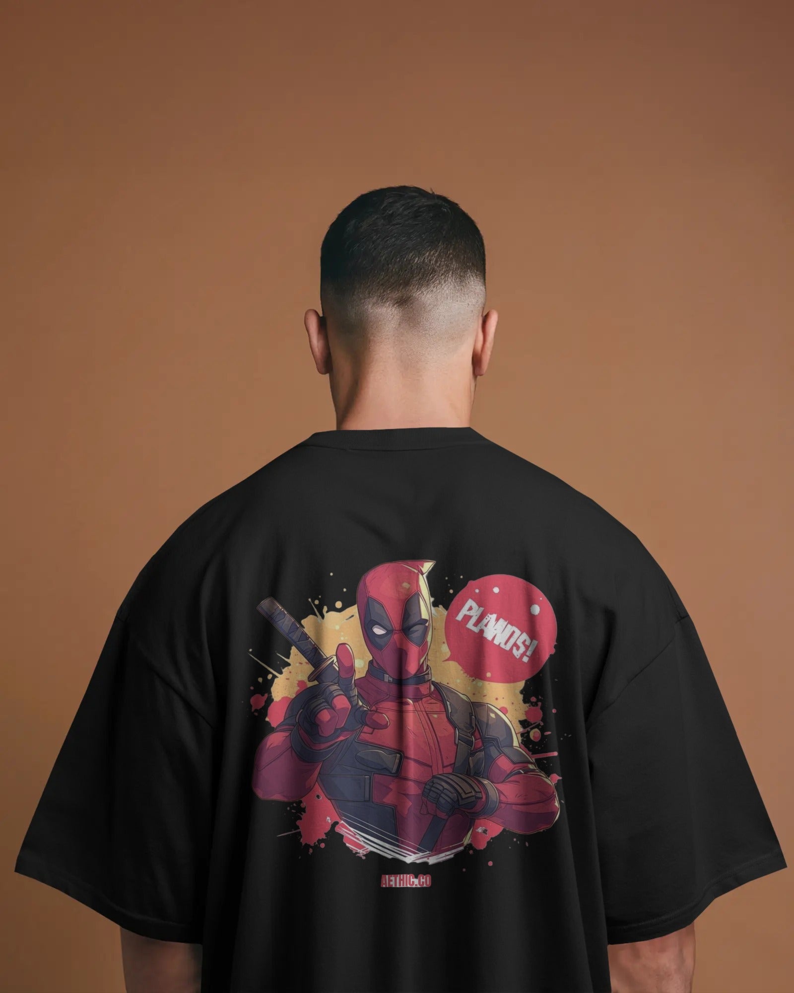 Person wearing a black t-shirt with a graphic of marvel character deadpool