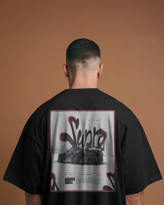 Person wearing a Colour_black t-shirt with 'Supra' graphic on the back against a brown background