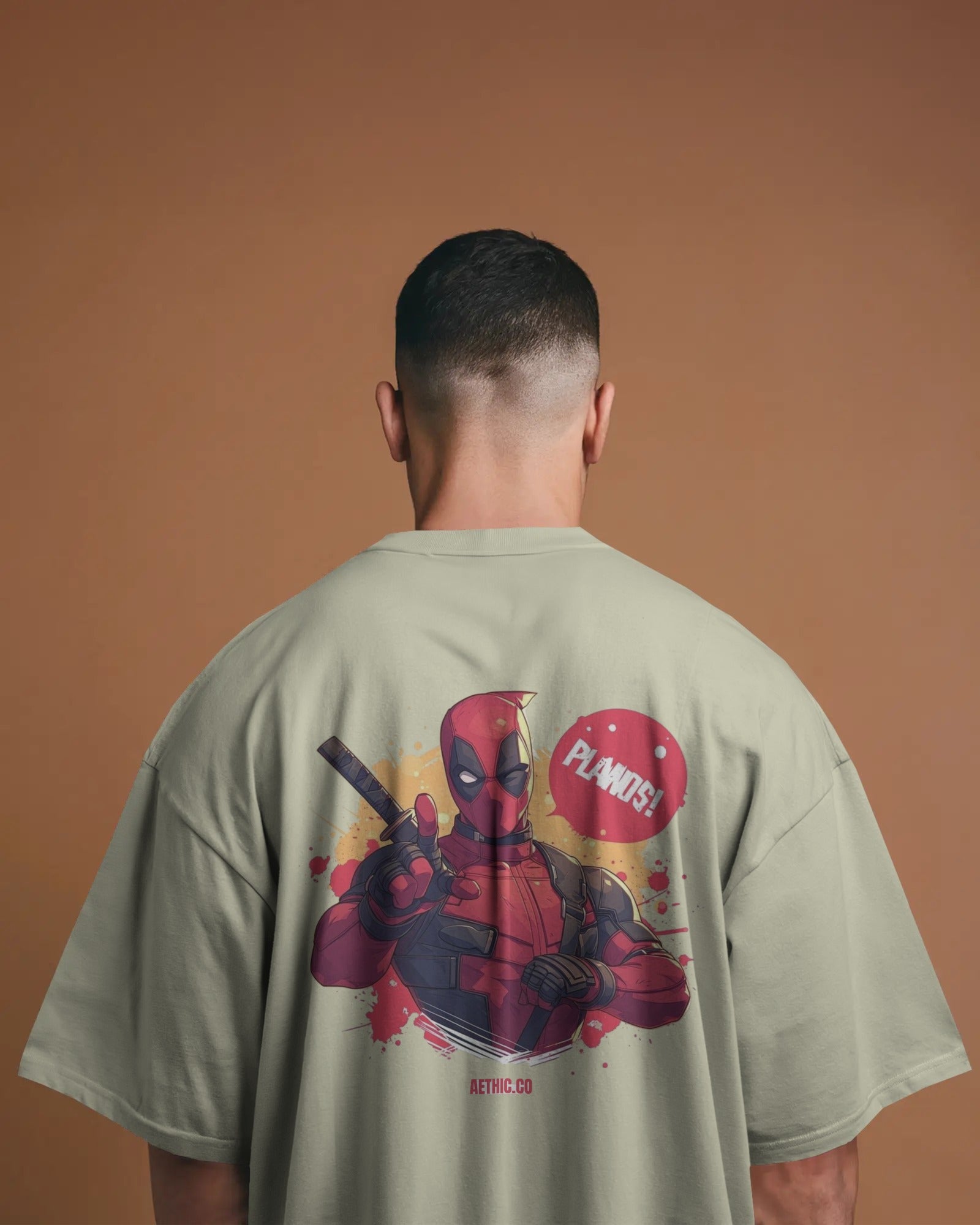 Person wearing a t-shirt with a Deadpool graphic on a offwhite tee