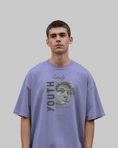 Person wearing a purple t-shirt with graphic design and text on a plain background