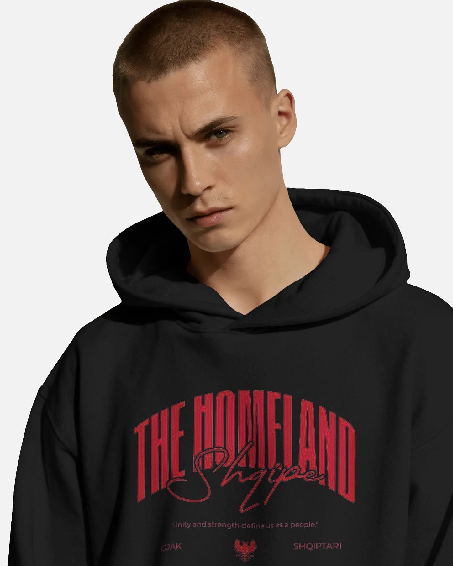 Person wearing a Colour_Black hoodie with red text on a plain background