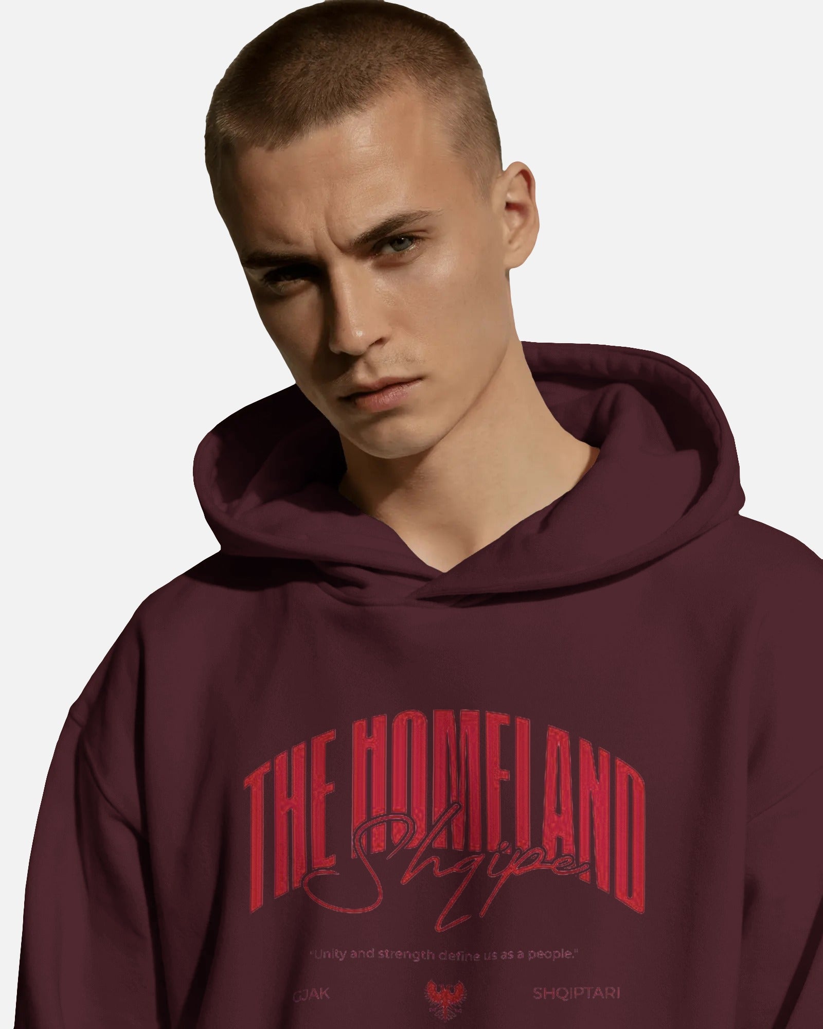 Person wearing a Colour_Maroon hoodie with red text on a plain background