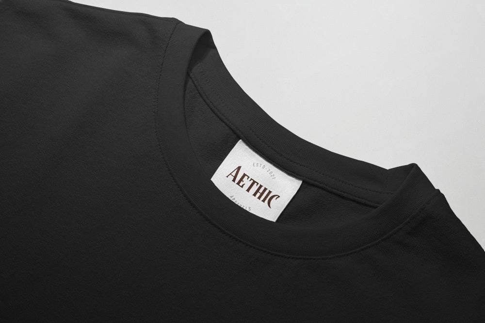Black t-shirt with 'AETHIC' label on a light gray background