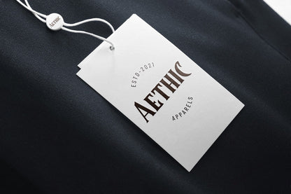 Aethic Apparels tag on a dark fabric background