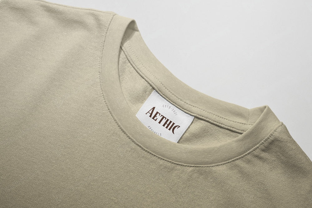 off white t-shirt with 'AETHIC' label on a light gray background