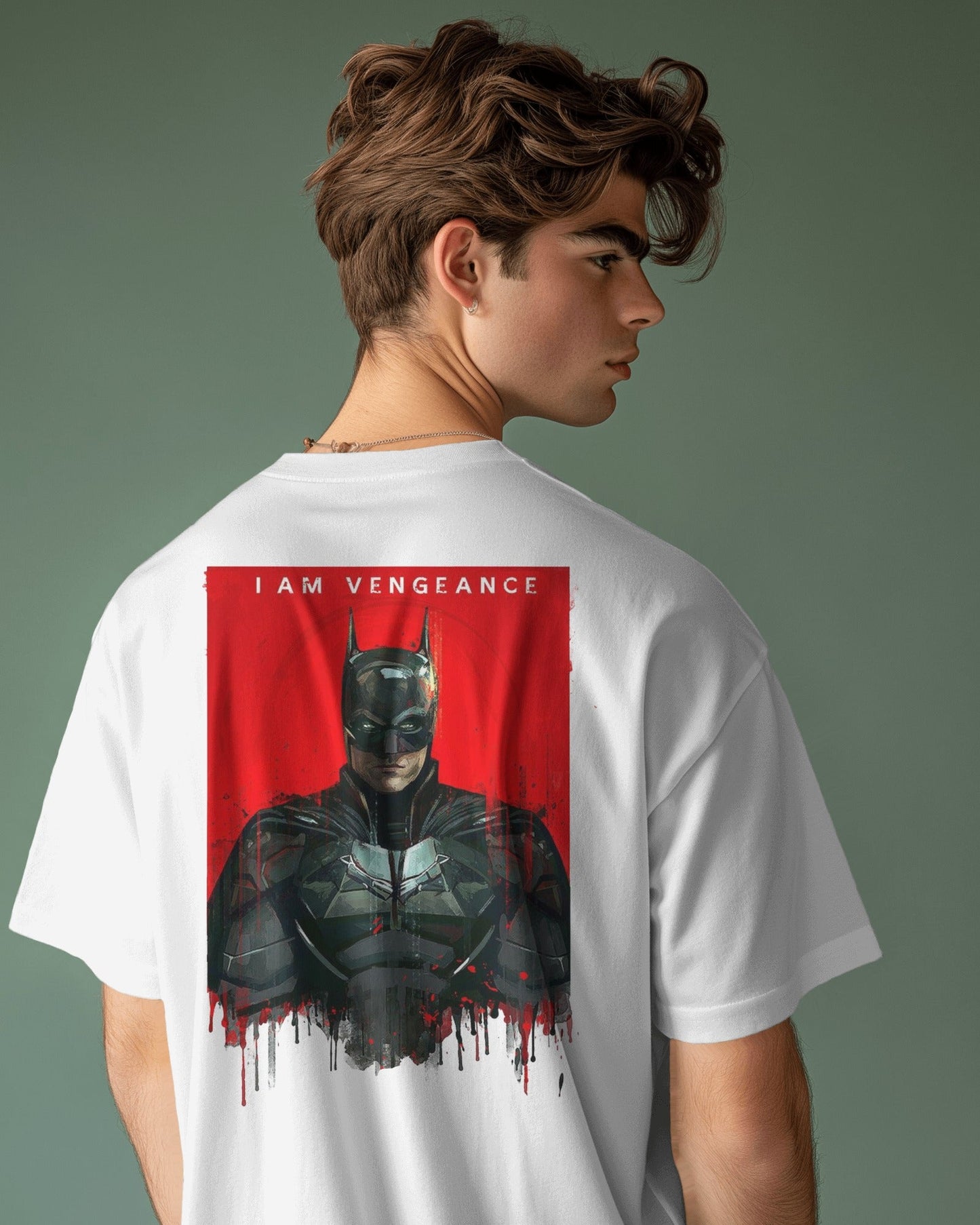Person wearing a white t-shirt with a graphic design of a character in a dark suit on the back, with text 'I AM VENGEANCE' on a gray background.